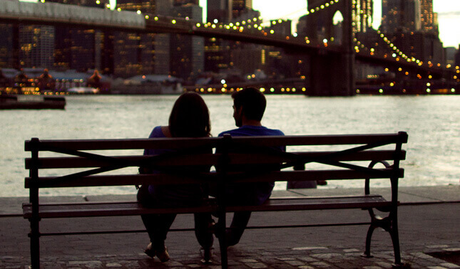 man and woman dating on a bench